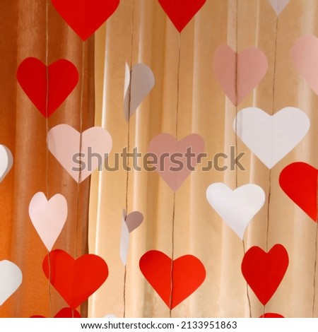 Defocus banner. Valentines Day background with paper hearts. The red and white heart shapes for 14 February. Love concept. Cupid's bow. Square backdrop. Holiday concept. Copy space. Out of focus.