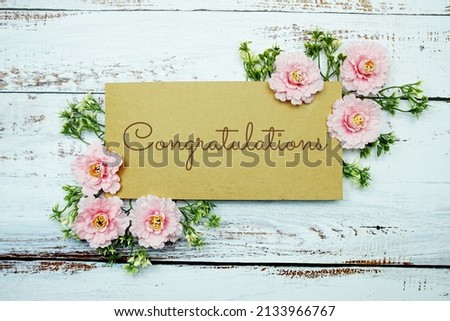 Congratulations typography text decorate with flower on wooden background