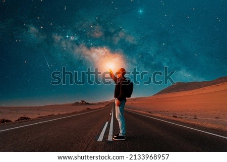 person on the road under the milky way at night Royalty-Free Stock Photo #2133968957