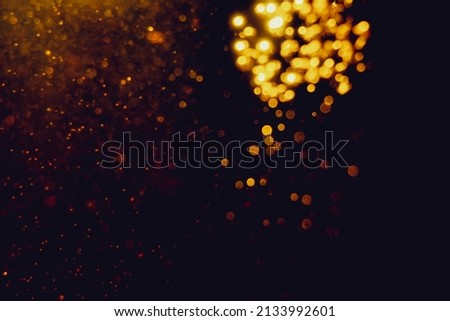 Glittering stars of blur gold  bokeh use for celebrate with black background