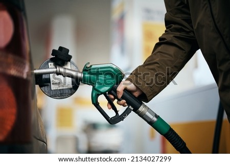Close-up of woman refueling the gas tank at fuel pump. Royalty-Free Stock Photo #2134027299