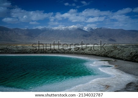 Chaka Salt Lake landscape with blue sky and Snow mountain background in northwest China.