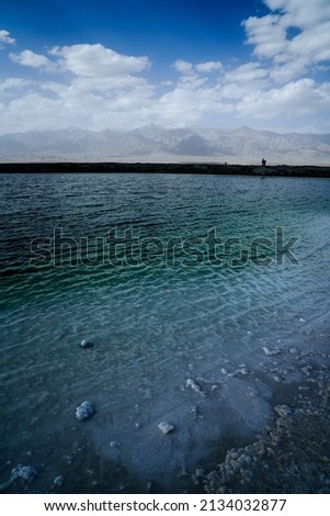 Chaka Salt Lake landscape with blue sky and Snow mountain background in northwest China.