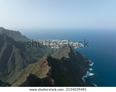 Mountain aerial of cliffs, high mountains, along the Atlantic coast line. Panoramic beautiful rough sea green rocky nature landscape. Tenerife, spain.