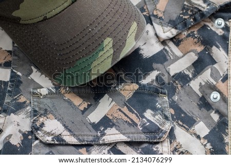 Camouflage patterned hat on a camouflage textured background