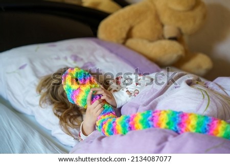 Cute little preschhol girl after sleeping in bed. Happy joyful smiling child wake up in the morning, healthy sleep of children by day