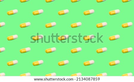 Yellow pills, capsules on a pale green background. pattern for the background, banner. Medical pharmacy bright design for presentation packaging, website flyer ,cover, business cards.