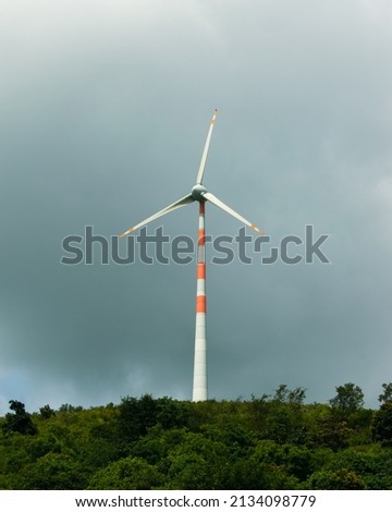 Close-up shot of wind turbine on the hill top.