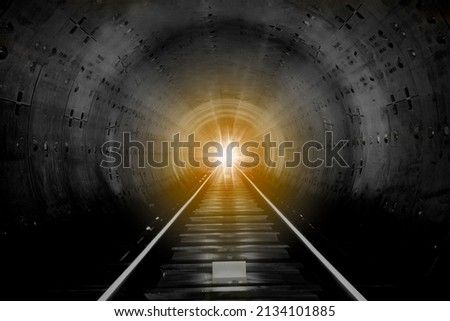 A look into a station tunnel. Fast underground train riding in a tunnel. Subway, underground, crossing in the tunnel, with front lighting Royalty-Free Stock Photo #2134101885