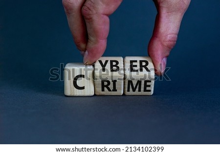Cyber crime symbol. Businessman turns wooden cubes with words 'Cyber crime'. Beautiful grey background. Cyber crime and business concept. Copy space.