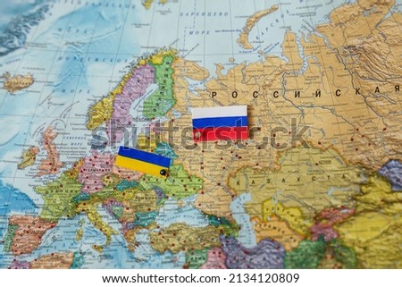 Flags of Russia and Ukraine on the political map of Europe. Conflict and Crisis of Ukraine and Russia. International relationships. Image with selective focus