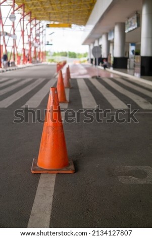road divider in the form of a cone with an orange color on a road, with a striking color the road divider will be easier for road users to see