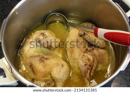 Cooked chicken stew with lemon broth, in a pot. "kotopoulo lemonato" traditional Greek food. Close up, selective focus