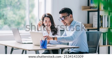 Two Asian businesspeople working at office Royalty-Free Stock Photo #2134143309