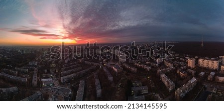 Aerial scenic vibrant sunset panorama wide view with epic skyscape. Kharkiv city center, Pavlove pole residential district streets and buildings in evening light
