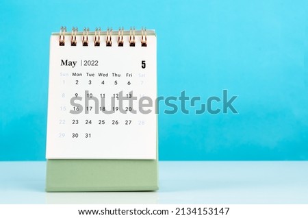 The mini May 2022 desk calendar on blue background. Royalty-Free Stock Photo #2134153147