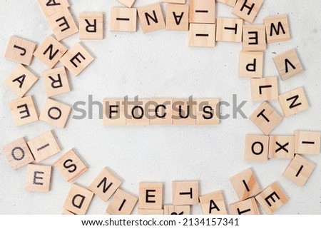 Top view of Focus word on wooden cube letter block on white background. Business concept