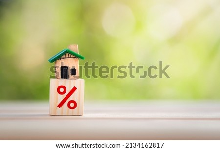 Interest rate financial and mortgage rates concept. House is placed on a wooden block with interest or tax rates,Mortgage rates business concept of investment real estate interest rates home appraisal Royalty-Free Stock Photo #2134162817