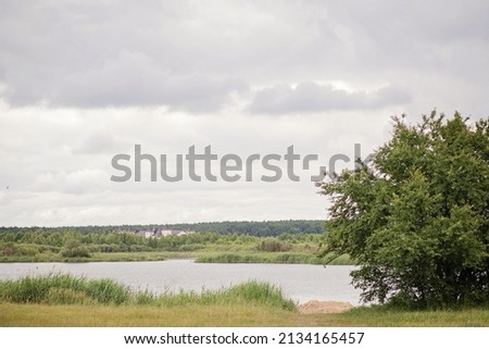 Gloomy sky over the lake. Natural landscape.