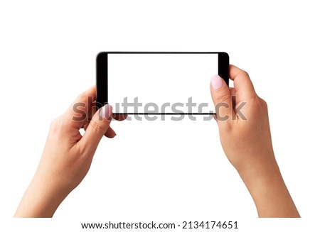 Smartphone with blank screen in woman’s hands - isolated on white background. Using phone to take horizontal photo.