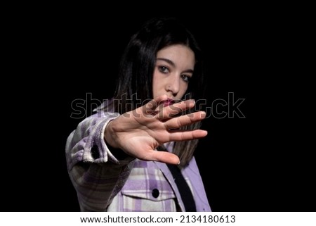 woman on black background ordering stop