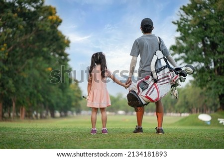 brother and sister on golf course