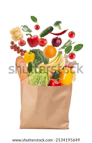 paper bag with fresh vegetables and other food