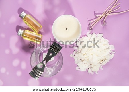 Set for homemade natural eco-friendly soy wax candles, wick, perfume, aroma oil. Candle making utensils.Trendy diy candles to health on pink background.Copy space.Cruelty-free vegan product.