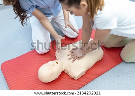 Demonstrating CPR (Cardiopulmonary resuscitation) training medical procedure on CPR doll in the class.Doctor and nurse students are learning how to rescue the patient.First aid for safe life concept.