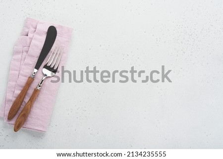 Vintage silverware. Rustic vintage set of wooden spoon and fork on light gray concrete background. Empty dishes. Top view. Mock up.
