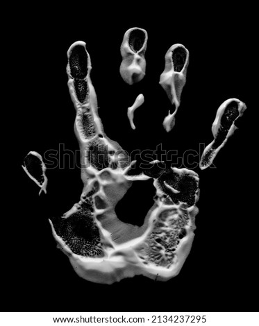 Hand print with shaving foam isolated on black, top view