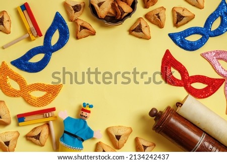 Purim Festival objects and Scroll of Esther on Yellow background.