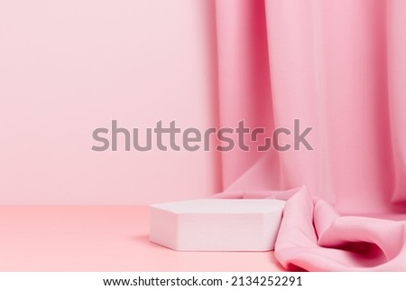 Geometric empty podium with textile fabric drape on pink background, display for product, cosmetic and perfume presentation Royalty-Free Stock Photo #2134252291