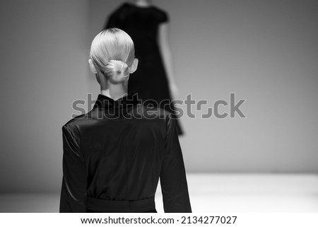 Fashion model at a catwalk during a fashion show or fashion week.