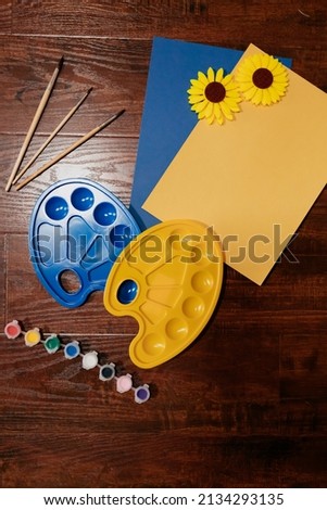 Picture in Ukrainian colours with blue and yellow palettes. Paint with sunflowers on yellow and blue background. Paint for support Ukraine. High quality photo