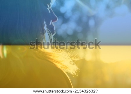 War Ukraine. Close-up silhouette of woman looking at sunrise. Mental health, hope, happiness concept. Dreams. Peace lifestyle. Open mind, new goals and decisions. Sunlight in fall park or forest.