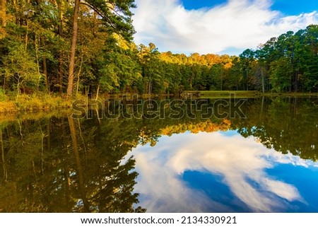 Fall Color Reflections on Sycamore Creek, William B. Umstead State Park, Raleigh, North Carolina, USA Royalty-Free Stock Photo #2134330921