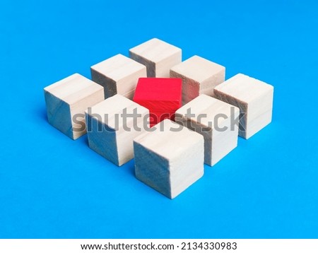 Diversity, individuality or difference concept. Wooden cubes with red color at the center against blue background. Royalty-Free Stock Photo #2134330983