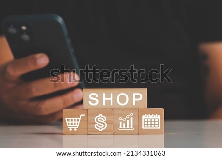 A man hand hold credit card to shopping online bill on wood block, Debit saving purchase buy on table background. People contactless pay money in restaurant, Person bank smart payment concept.
