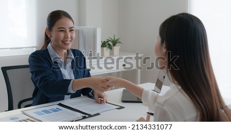 Asia startup SME woman people happy smile talking in wealth service plan advice deal, home loan will at lawyer desk sale office. HR job consult sign in legal paper. Bank trust in Trader tax agent. Royalty-Free Stock Photo #2134331077