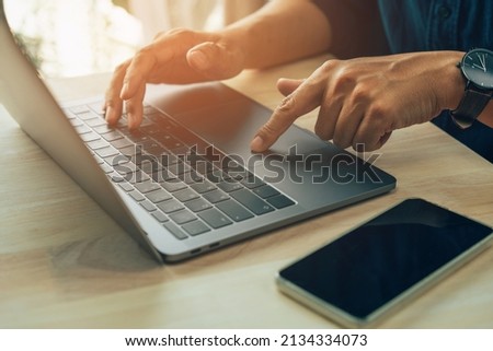 Fingers touch keyboard concept, Closeup photo of male hands with laptop, businessman working at home office.