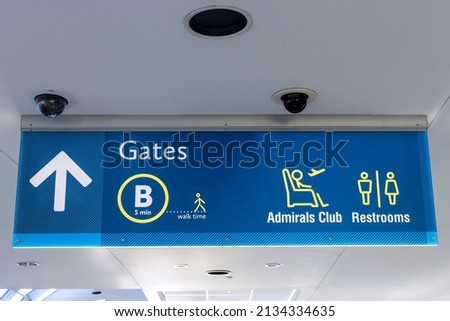 International Airport sign Gates B Admirals Club Restrooms in air terminal