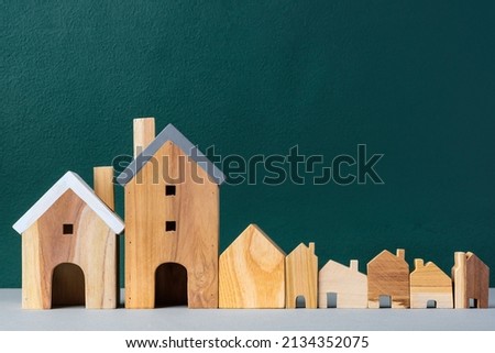 set of wooden house and tree decoration in village on grey floor and green background