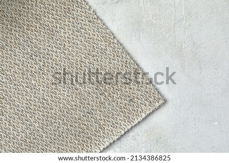 abstract texture of rough cotton fabric or canvas with drawing from fibers a cross crosswise for backgrounds of gray color