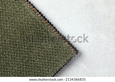 Green linen cloth close-up background. Fabric khaki teak canvas texture