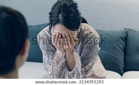 Crying woman in the room.  Royalty-Free Stock Photo #2134391293