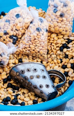 Container with lupins and a dispenser at a street stall.