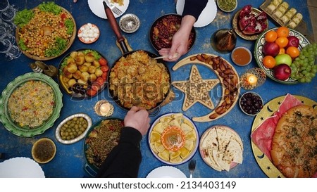 Ramadan iftar Eid. Muslim family has dinner at home. Table with traditional food. Eid al-Fitr celebrations Royalty-Free Stock Photo #2134403149