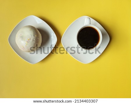 Cups of hot black coffee and sweet donuts on yellow background. Top view, copy space, mockup. Flat lay. Food and drinks. Spring holidays. 