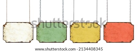 Four empty vintage tin signs hanging on a white background